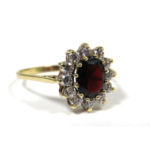 322 - 9ct Yellow Gold Ring set with a Central Garnet (10 x 6mm) with CZ surround.  Finger size 'T'  2.2g