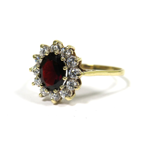 322 - 9ct Yellow Gold Ring set with a Central Garnet (10 x 6mm) with CZ surround.  Finger size 'T'  2.2g