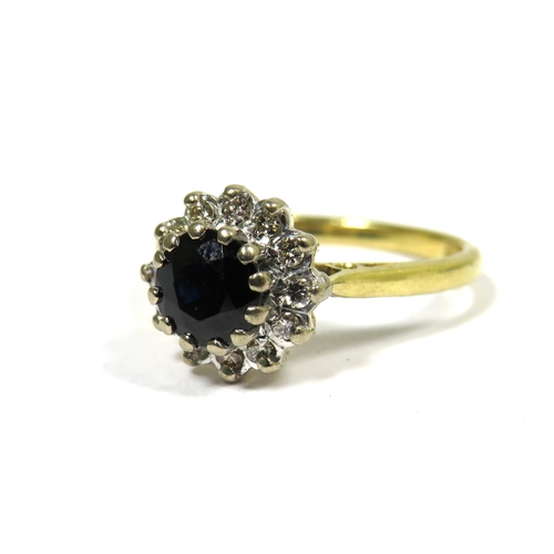 323 - 18ct Yellow Gold Ring set with a Central Circular Sapphire with Diamond Surround. Finger size 'M'   ... 