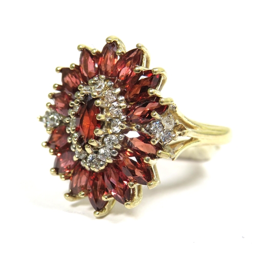 324 - 9ct Yellow Gold Ring set with a Central Garnet with Diamond Surround and sides.  Finger size 'M'   5... 