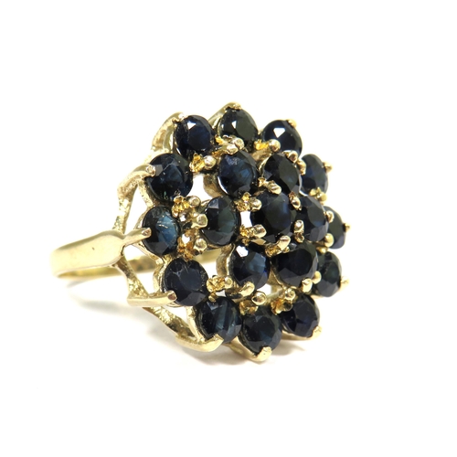 327 - 9ct Yellow Gold Ring set with Multiple 3mm Sapphires in a Flower pattern.  Finger size 'O'   4.8g