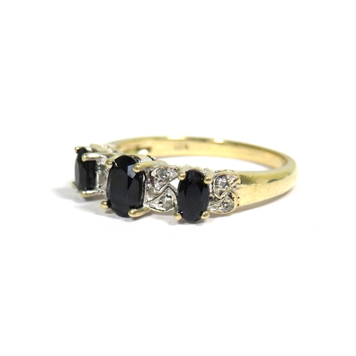 335 - 9ct Yellow Gold Ring set with a Trio of Sapphires (6 x 4mm & 4 x 3mm) Surrounded by Small Diamonds. ... 