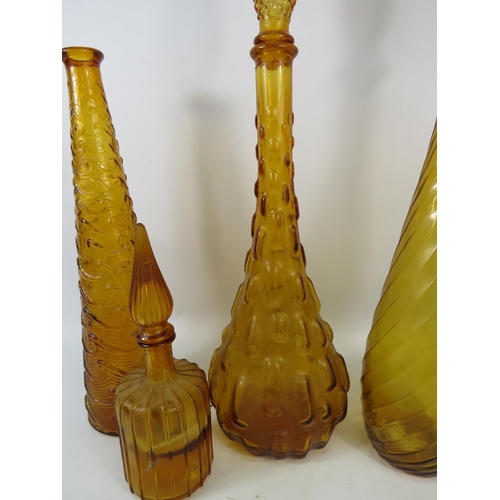 284 - Three Amber Italian glass Empoli style genie bottles plus one smaller. Three with stoppers.