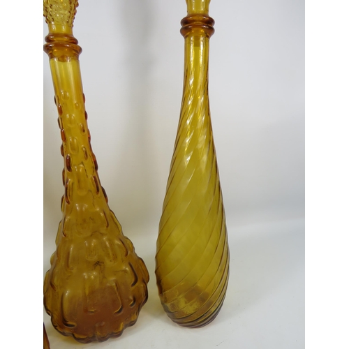 284 - Three Amber Italian glass Empoli style genie bottles plus one smaller. Three with stoppers.