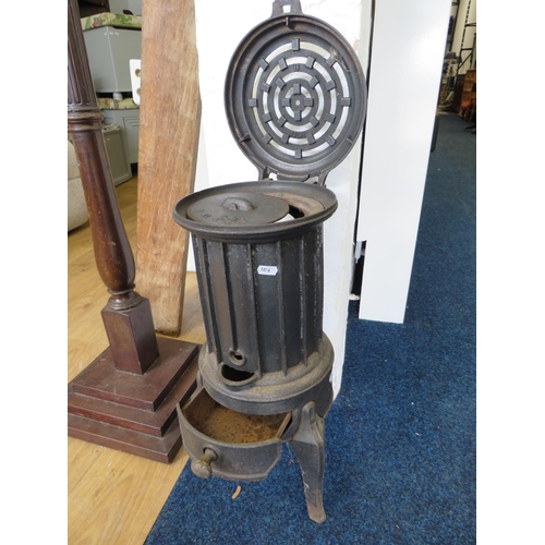 1016 - Small Cast Iron Pot Stove by Faure. No damage apparent. H:23 inches Tall.