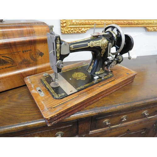 1027 - Antique Sewing Machine with case. Appears to be in working order. See photos.