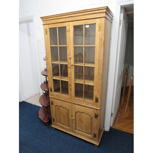 1030 - Stripped Oak Glazed Bookcase with cupboard below. H:72 x W:33 s D:15 inches. See photos.