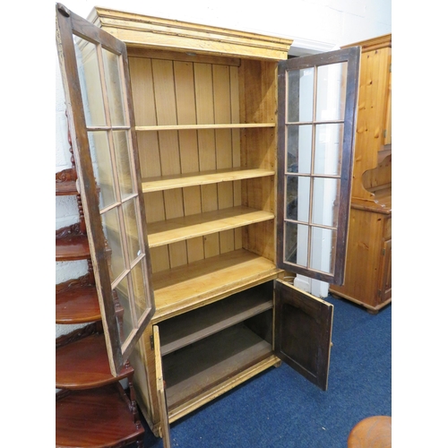 1030 - Stripped Oak Glazed Bookcase with cupboard below. H:72 x W:33 s D:15 inches. See photos.