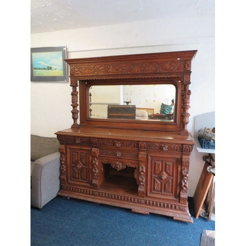 1051 - Large and heavy Oak Carved Mirror backed dresser with lots of decorative Carving