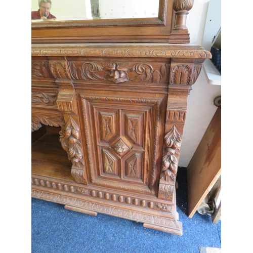 1051 - Large and heavy Oak Carved Mirror backed dresser with lots of decorative Carving