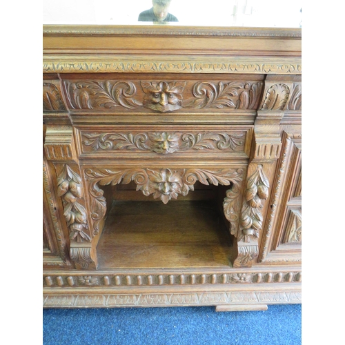 1051 - Large and heavy Oak Carved Mirror backed dresser with lots of decorative Carving