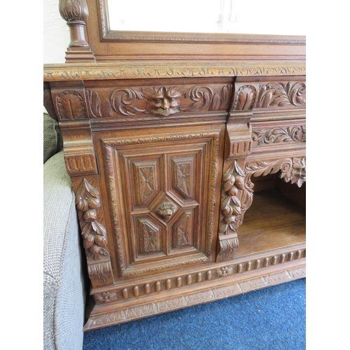 1051 - Large and heavy Oak Carved Mirror backed dresser with lots of decorative Carving