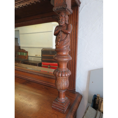 1051 - Large and heavy Oak Carved Mirror backed dresser with lots of decorative Carving