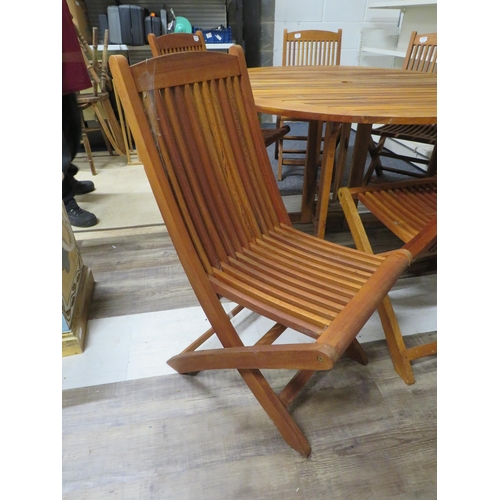 1052 - Circular Drop leaf Teak Garden table with six matching folding chairs. All in good order. See photos... 