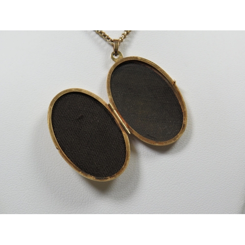 365 - 9ct Gold Locket set with a central Oval Sapphire attached to a 24 inch 9ct Yellow gold Chain.  Total... 