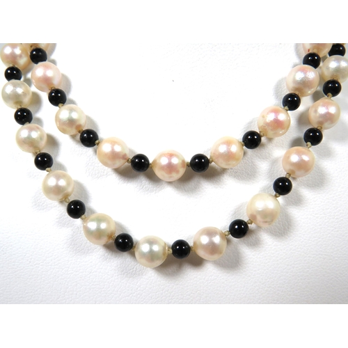 514 - String of Natural Pearls with black bead spacers.  9ct Clasp.  22 inches long.  See photos.