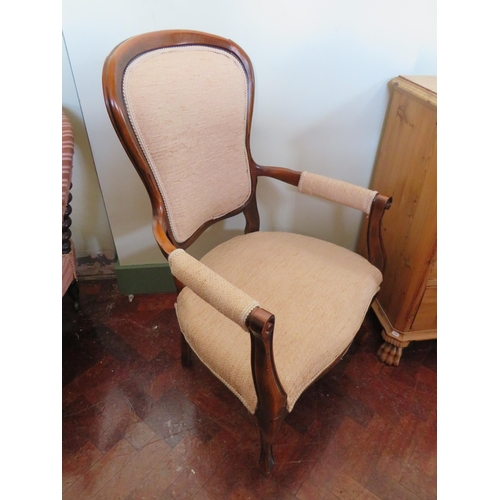 555 - Low Armchair with Mahogany frame. Nicely upholstered in Beige.  See photos.