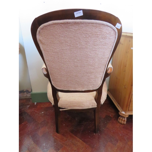 555 - Low Armchair with Mahogany frame. Nicely upholstered in Beige.  See photos.