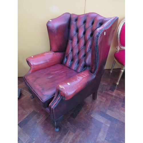 560 - Vintage Red Leather Chesterfield wing back chair in worn condition. Will need patches to arms. See p... 