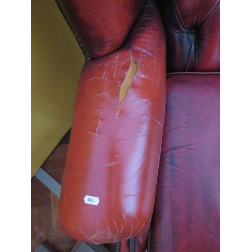 560 - Vintage Red Leather Chesterfield wing back chair in worn condition. Will need patches to arms. See p... 