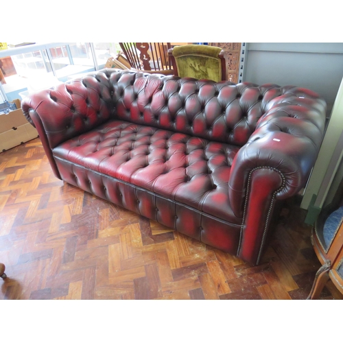 565 - Three Seater Chesterfield settee in Oxblood Leather. Very good condition.  H:30 x W:77 x D:36 inches... 