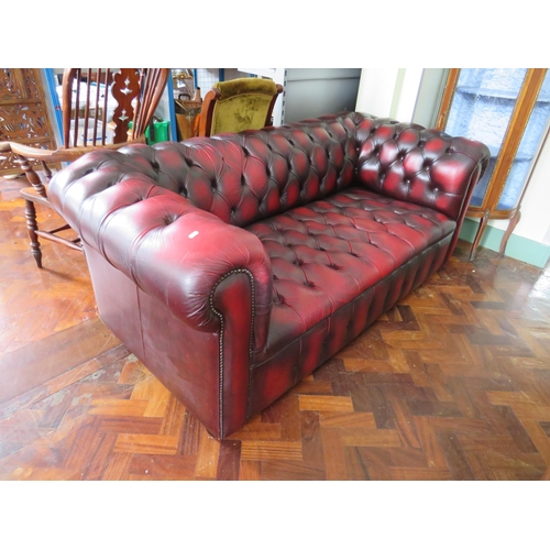 565 - Three Seater Chesterfield settee in Oxblood Leather. Very good condition.  H:30 x W:77 x D:36 inches... 