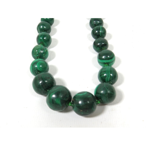 582 - 22 inch String of Graduated Banded Malachite beads. Quite heavy in good condition