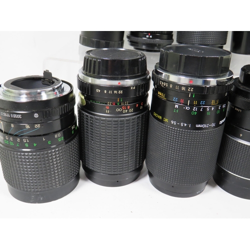 586 - Twelve assorted SLR camera lens by various makers to include Miranda and others.