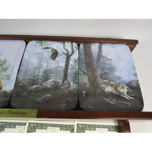 654 - Bradford exchange Nature Harmony plate set and wooden plate rack with certs.