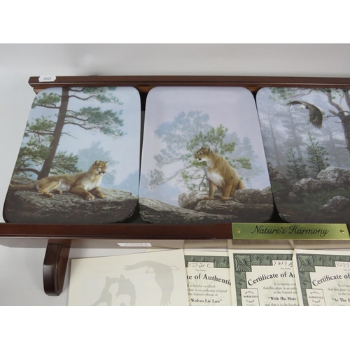 654 - Bradford exchange Nature Harmony plate set and wooden plate rack with certs.