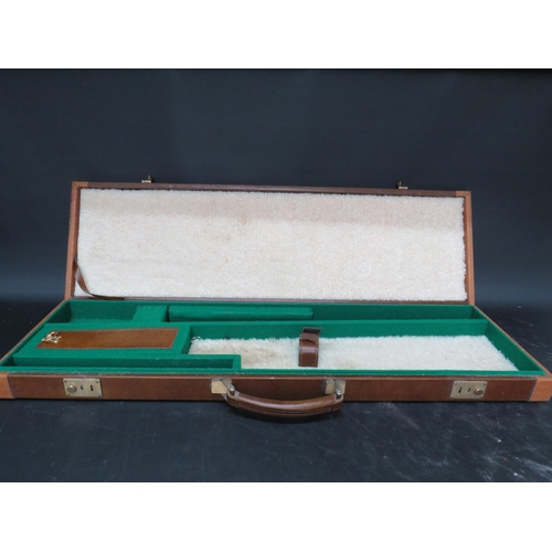 710 - A Browning leather gun case with keys.