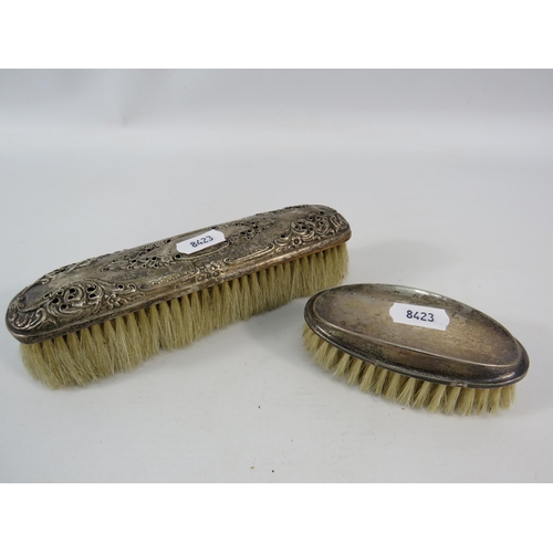 785 - Two sterling silver topped clothes brushes, Birmingham 1927 & 1898.