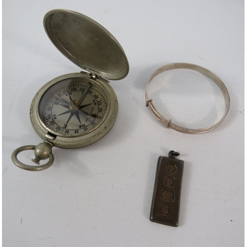 793 - White metal US compass, a sterling silver ingot and a sterling silver childs bracelet.