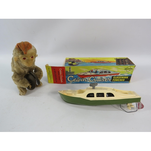 815 - Vintage clockwork monkey and cabin cruiser boat with box, both working with keys.