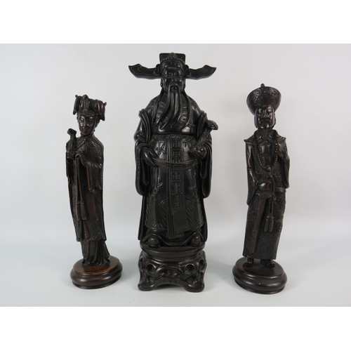 33 - A chinese resin Emperor figurine plus two others, the tallest stands, 12 3/4