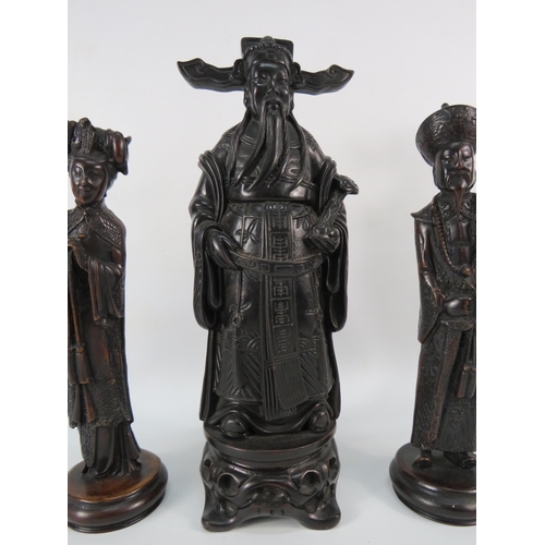 33 - A chinese resin Emperor figurine plus two others, the tallest stands, 12 3/4