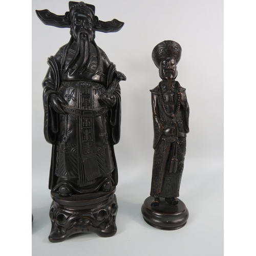 33 - A chinese resin Emperor figurine plus two others, the tallest stands, 12 3/4