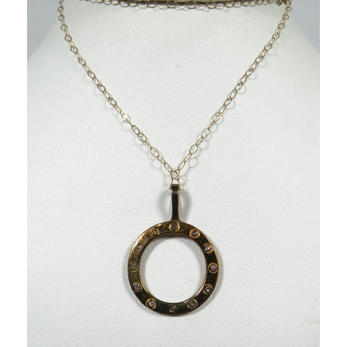 114 - 9ct Yellow Gold Circular 'Porthole' Pendant set with 12 Tiny Diamonds hung upon a 16 inch 9ct Yellow... 