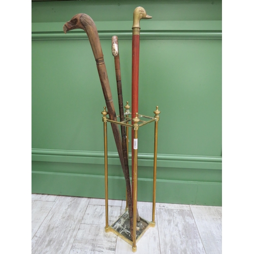 82 - Vintage brass stick stand and three walking sticks.