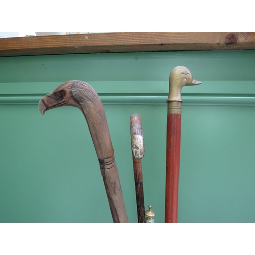 82 - Vintage brass stick stand and three walking sticks.