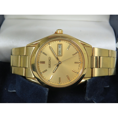 144 - Two Gents Seiko Quart Watches, one in Silver tone and one Gold tone. One with box. Both have date wi... 