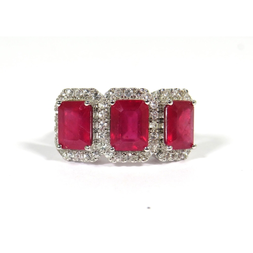 161 - 9ct White Gold Ring set with a trio of Lab grown Emerald Cut African Rubies with white Sapphire surr... 