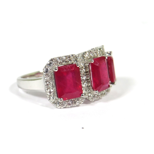 161 - 9ct White Gold Ring set with a trio of Lab grown Emerald Cut African Rubies with white Sapphire surr... 