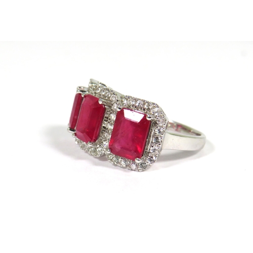 161 - 9ct White Gold Ring set with a trio of Lab grown Emerald Cut African Rubies with white Sapphire surr... 