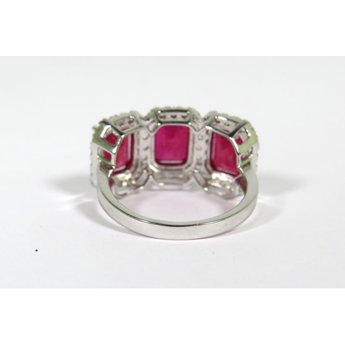 161 - 9ct White Gold Ring set with a trio of Lab grown Emerald Cut African Rubies with white Sapphire surr... 