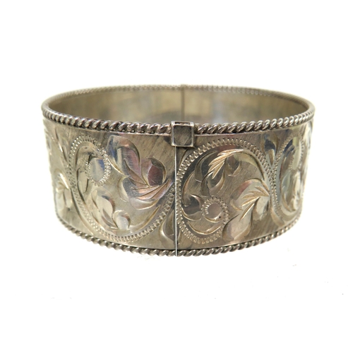 178 - Heavy Silver oval Bangle Bracelet with good hinge and clasp. Nicely Scrolled decoration all around w... 