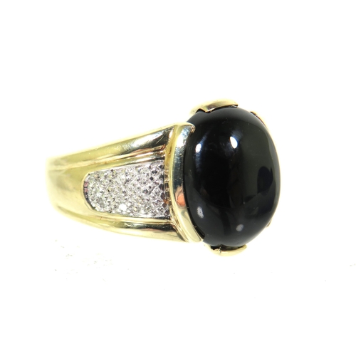 182 - 9ct Yellow Gold ring set with a large oval Onyx which measures 13 x 11 inches with small clear gemst... 