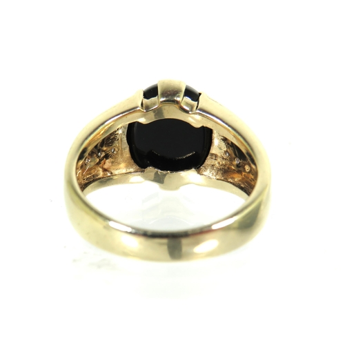 182 - 9ct Yellow Gold ring set with a large oval Onyx which measures 13 x 11 inches with small clear gemst... 