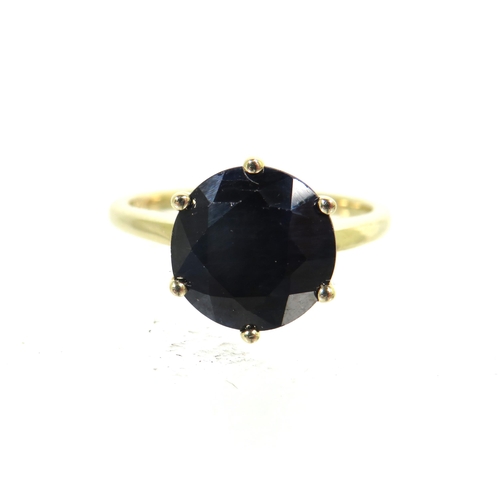 183 - 9ct Yellow Gold Ring set with a large Circular Sapphire which measures approx 100 in diameter.  Fing... 