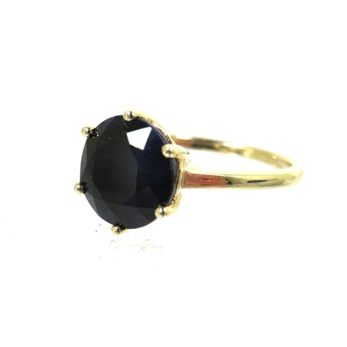 183 - 9ct Yellow Gold Ring set with a large Circular Sapphire which measures approx 100 in diameter.  Fing... 